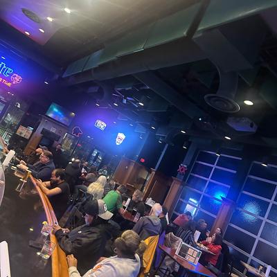 People enjoying drinks at the bar.