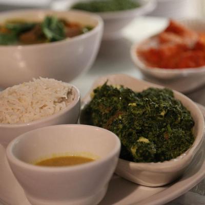 Saag dish made of spinach, served with a side of rice and soup