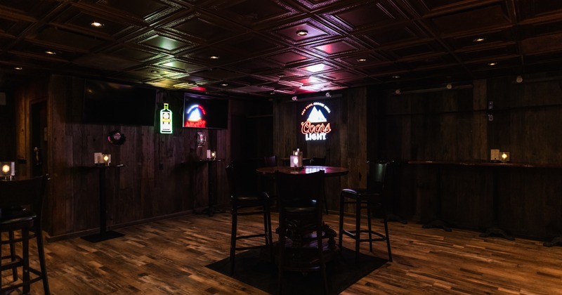 Bar area, table and stools in the middle
