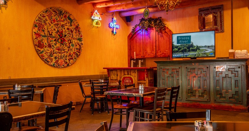 Interior, tables and chairs near bar