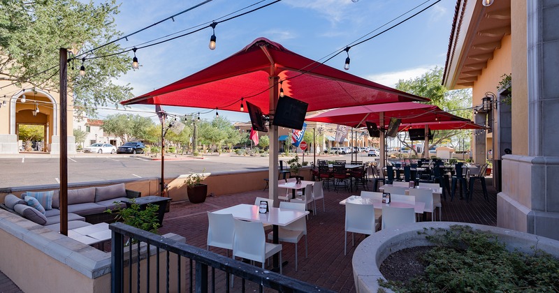 Exterior, patio tables with chairs and red parasols