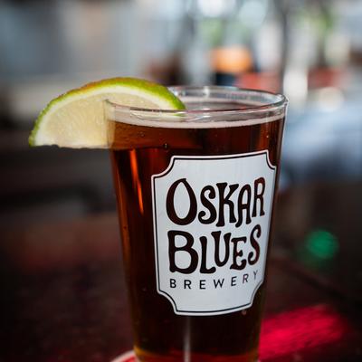 A glass of beer with a lime wedge.