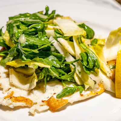 Grilled chicken breast topped with arugula and shaved parmesan.