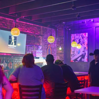 Customers sitting at the bar.