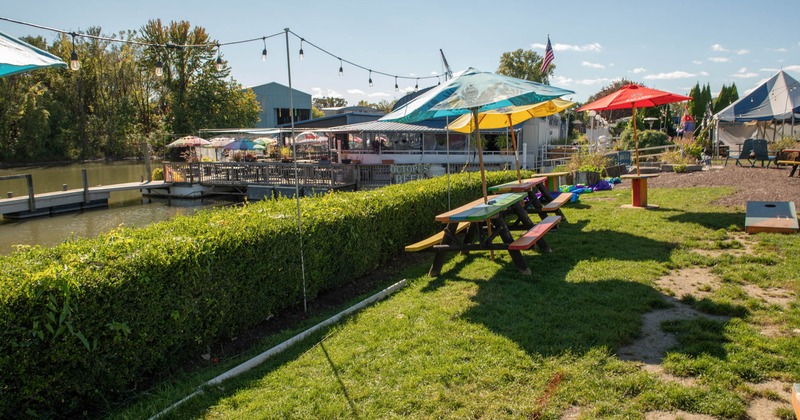 Outdoor space with picnic tables by a hedge