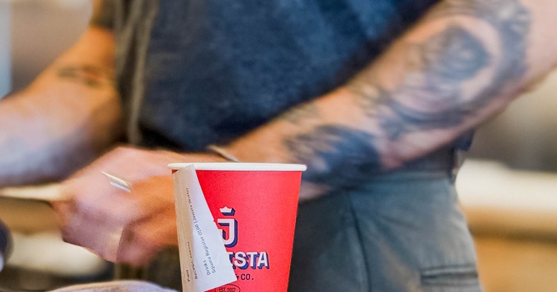 Employee and a paper coffee cup