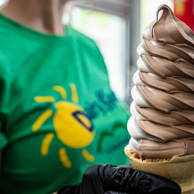Employee holding an ice cream cone in their hand.