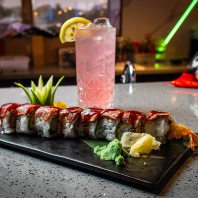 Samurai surf roll accompanied by wasabi, pickled ginger, and a drink.