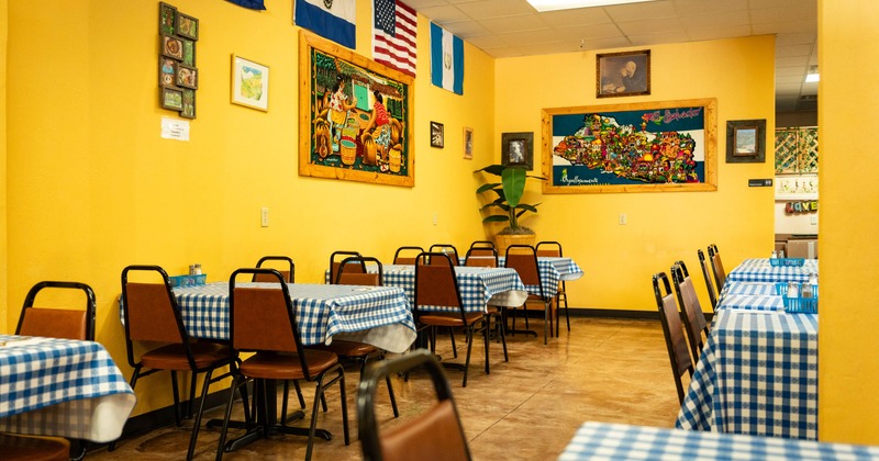 Interior, dining area, tables for four with blue & white checkered cloths,  tile flooring