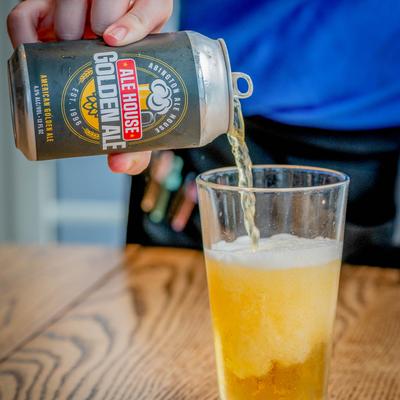 Ale House Golden Ale is being poured form the can into a glass.