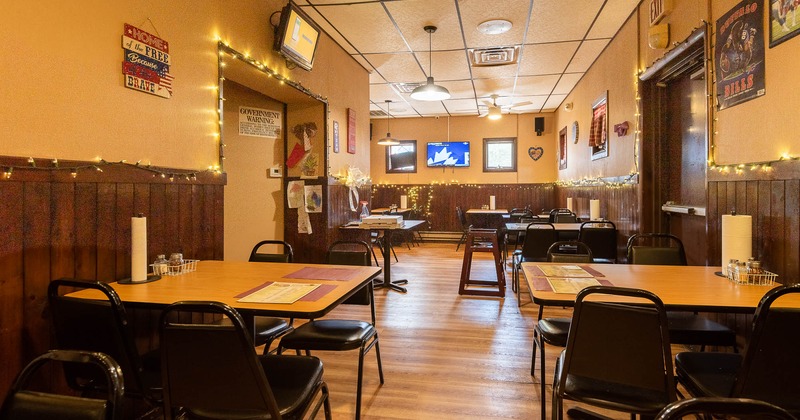 Interior, seating area with tables and decoration on the wall