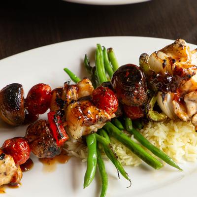 Bourbon Chicken Skewers, with bell pepper, onion, mushrooms, tomato, and jasmine rice