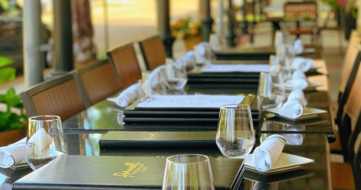 Interior, closeup of lined up tables with tableware