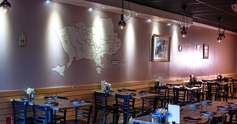 Interior, chairs and tables, a drawn map of the Balkans on the wall