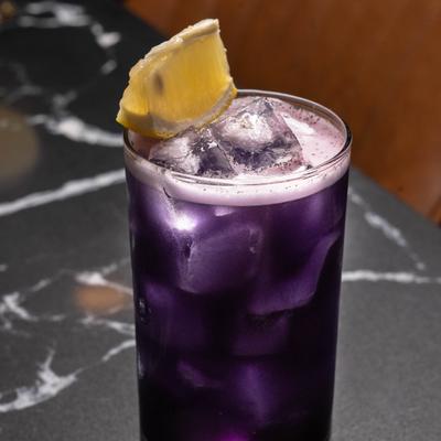 Darkness Falls cocktail with lemon garnish.