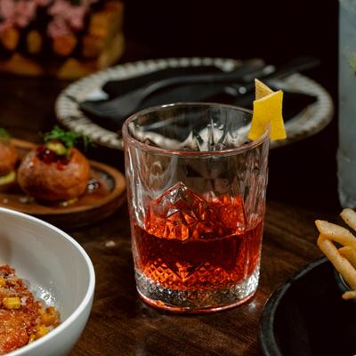 Cocktail surrounded by different dishes.