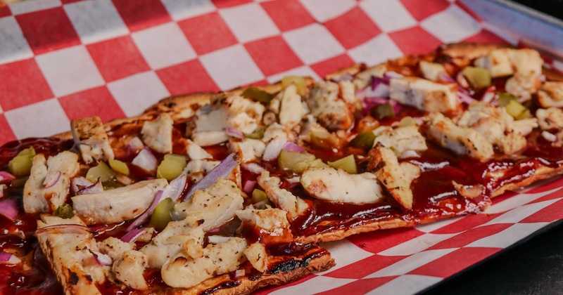 BBQ chicken flatbread pizza on checkered paper