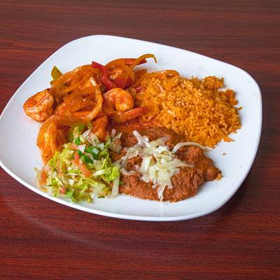 Sautéed shrimp served with rice, beans and a salad.