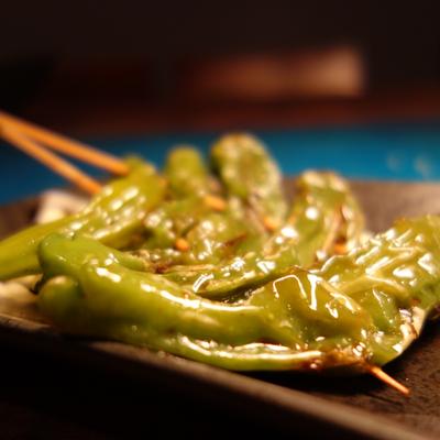 Grilled shishito peppers, close up.