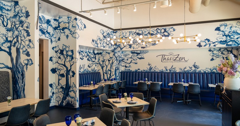 Modern and stylish restaurant interior dining area with elegant blue-and-white mural artwork