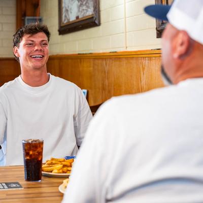 A couple of customers engaged in conversation during a meal.
