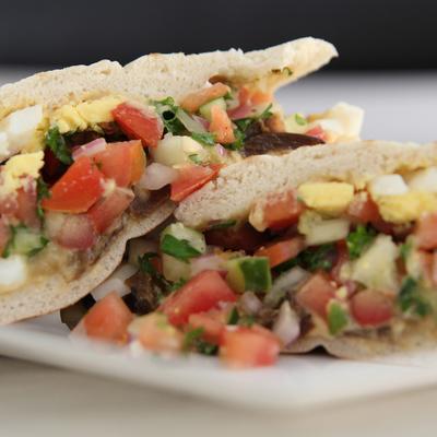 Classic Mediterranean sandwich with chopped veggies and hard bioled egg.