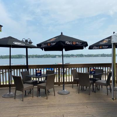 Outside seating area with beach umbrellas overlooking the lake.