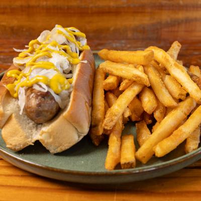 Bratwurst topped with sauerkraut and mustard, served with fries.