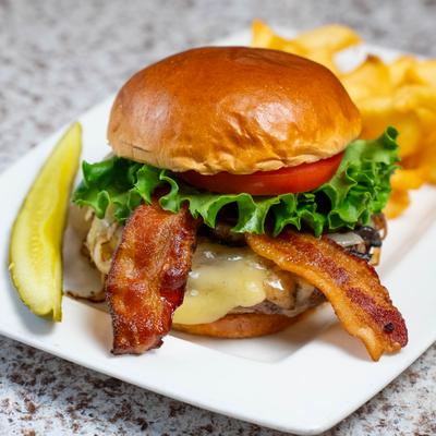 Grubby Burger with a pickle spear and fries.