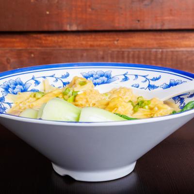 Wonton noodle soup with bok choy and scallions.