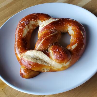 Pretzel served on a white plate.