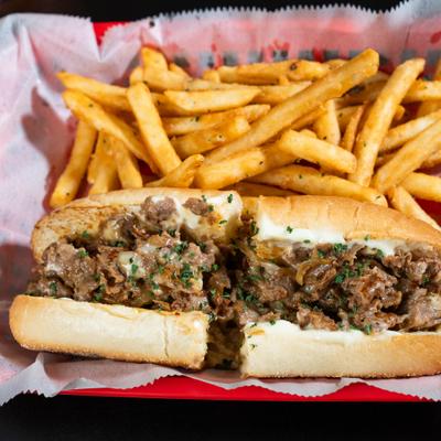 Philly Cheesesteak sandwich and fries.