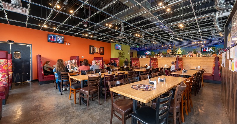 Interior, dining area, guests chatting and enjoying their food and drinks