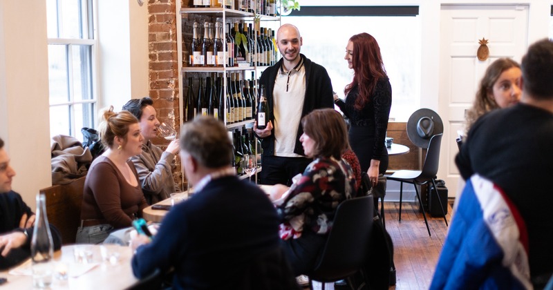 Interior, table, guests, stuff, wine rack behind