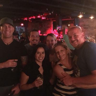 Interior, a group of customers  posing together for a shot.