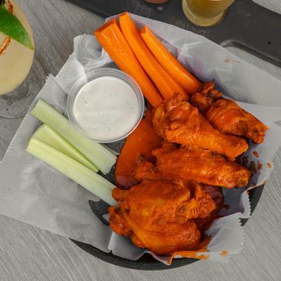 Buffalo wings, with celery, carrots, and dip.