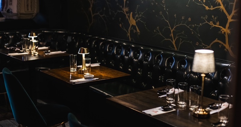 Modern style of interior design, dining tables lined up and ready for guests