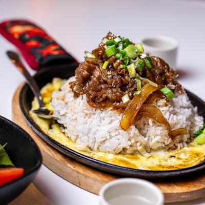 Rice topped with fatty beef and onions.