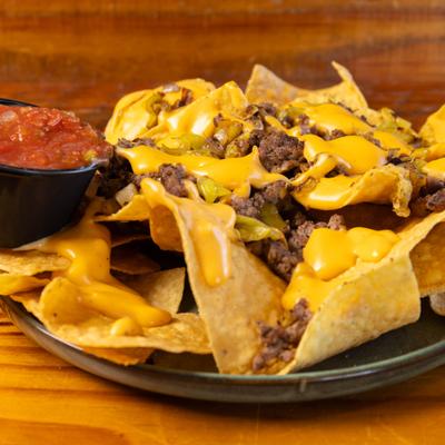 Beef nachos with melted cheese and salsa.