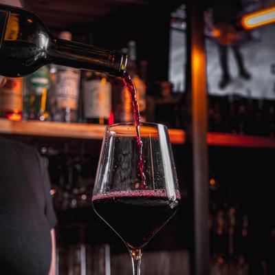 Red wine poured into a glass.