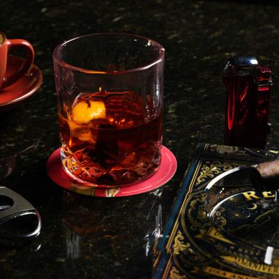 Negroni cocktail served in a textured lowball glass with an orange peel garnish.