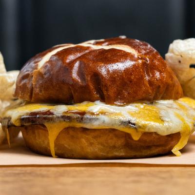 Bologna Sandwich with melted cheese on a pretzel bun.