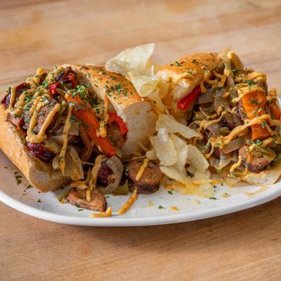 Sausage sandwich with vegetables and sauce.