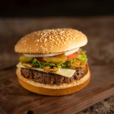 Cheeseburger with fried jalapenos, pickles, lettuce, tomato, and onion.