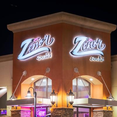 Restaurant exterior with neon signs.