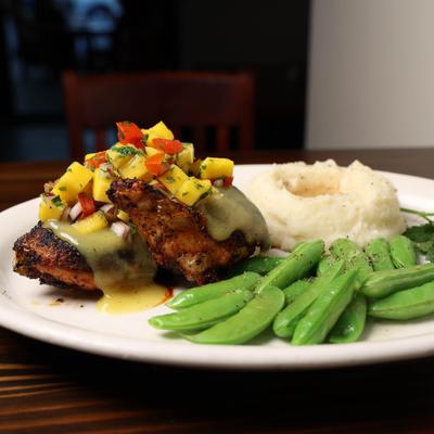 Jerk Chicken with snap peas and mashed potatoes.