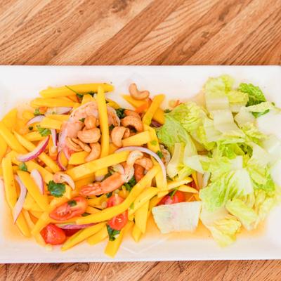 Mango Prawn Salad with carrots, cashew nuts, onions and lettuce.