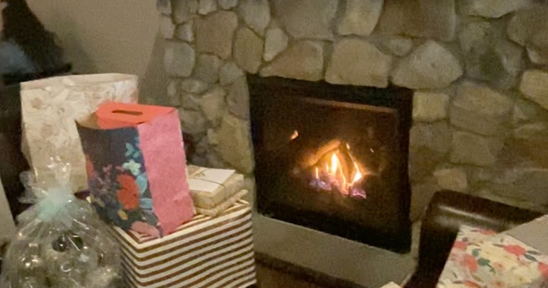 Gifts by a stone wall with gas fireplace