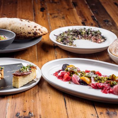 Assorted dish plates on a rustic wooden table.