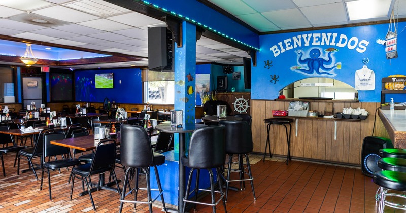 Inside space, one tall table and bar stools